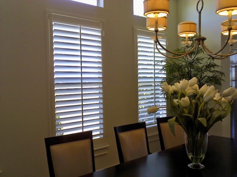 White plantation shutters fitted to dining room windows in a Sarasota County home